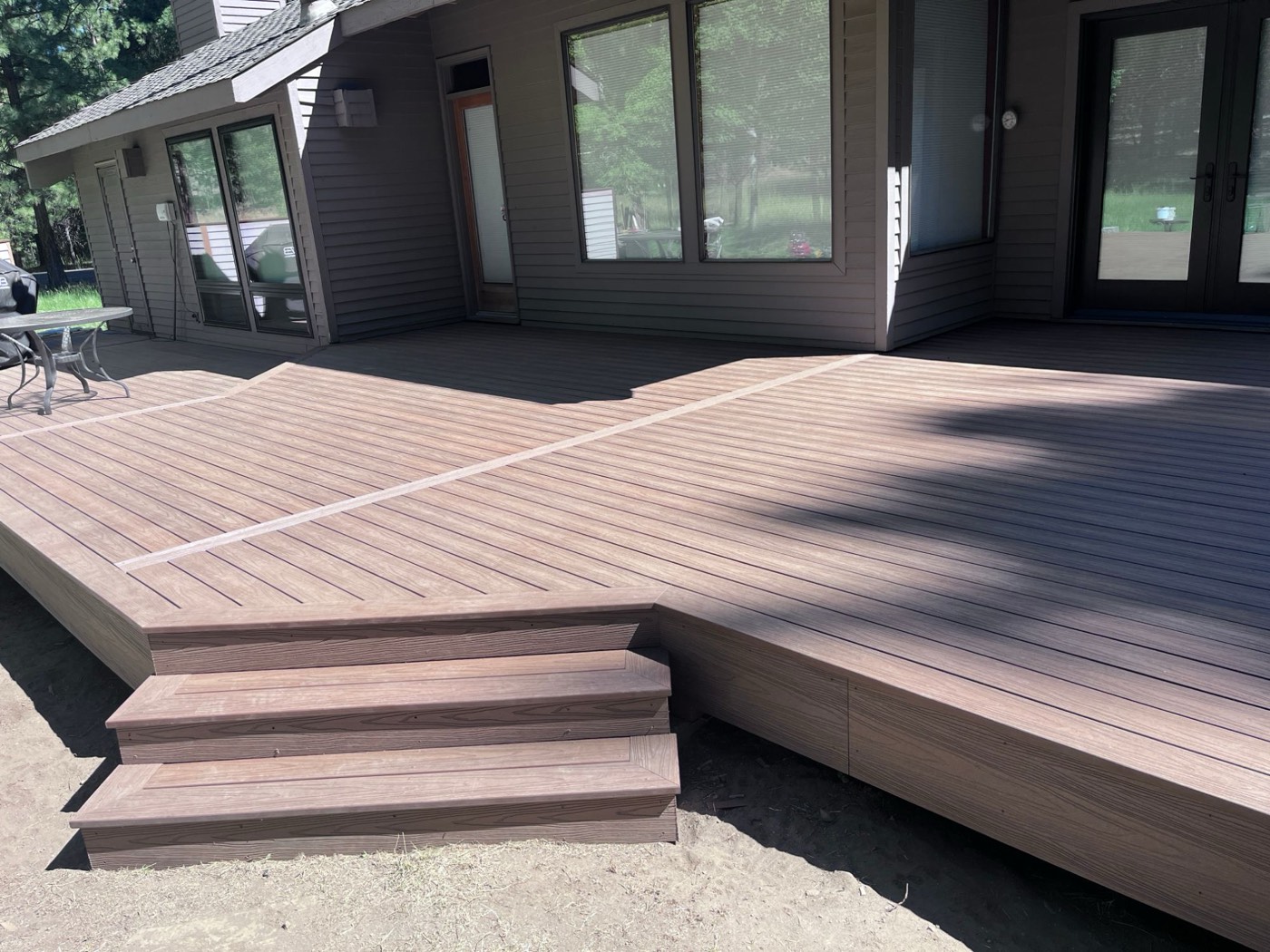 Multi-level composite deck with picture-frame border and wide box steps