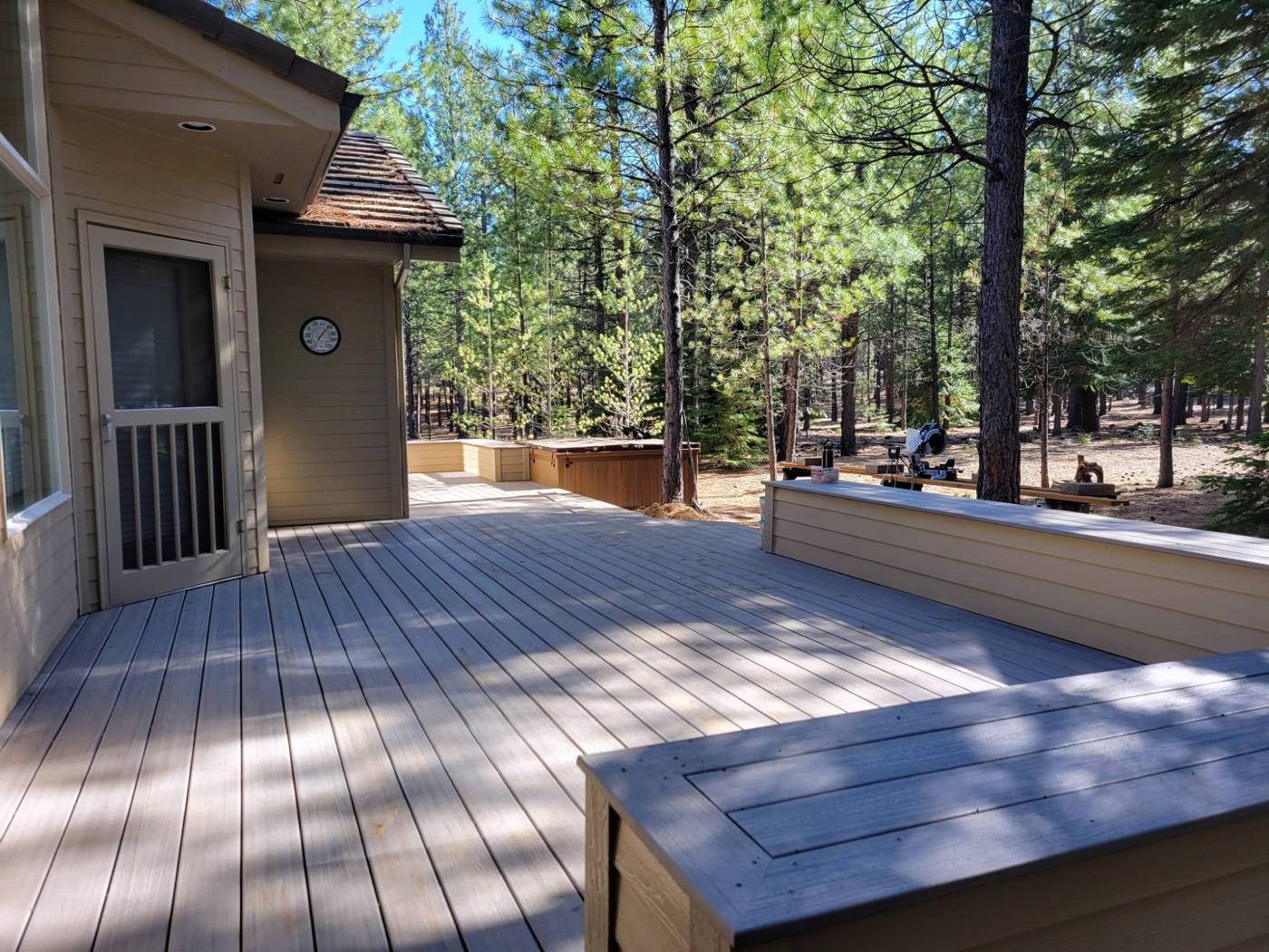 Open deck with bench seating under the pines